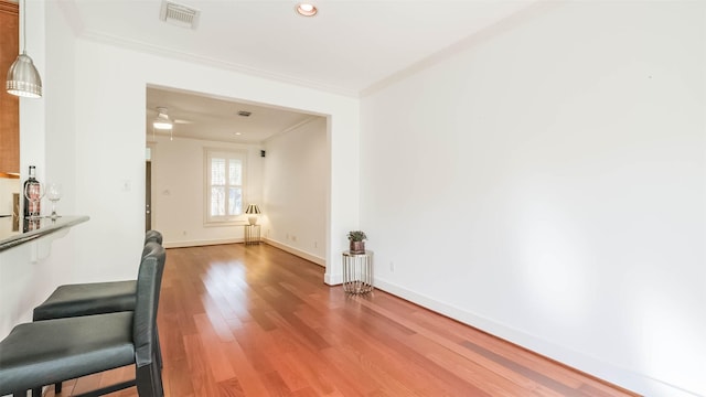 1045 W 16th St, Houston, TX 77008 - unfurnished living room with ornamental molding, light wood-type flooring, and recessed lighting