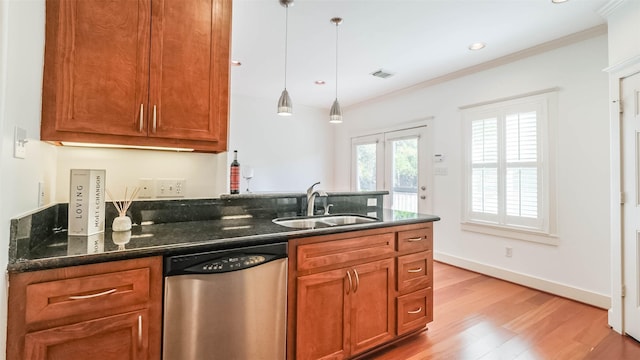 1045 W 16th St, Houston, TX 77008 - kitchen with stainless steel dishwasher, light wood-type flooring, brown cabinetry, decorative light fixtures, and crown molding