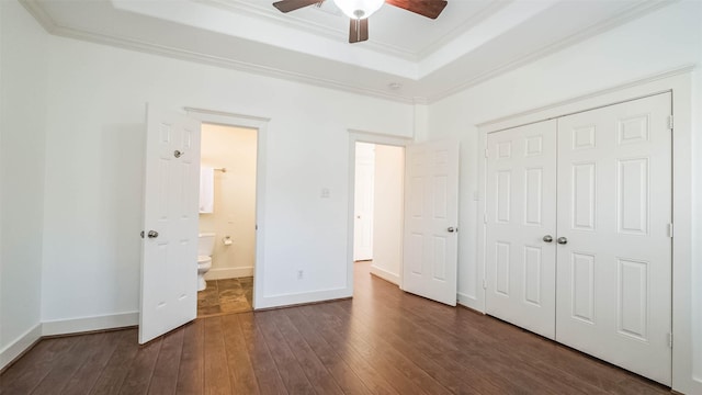 1045 W 16th St, Houston, TX 77008 - unfurnished bedroom with a tray ceiling, ornamental molding, dark wood-type flooring, a closet, and a ceiling fan