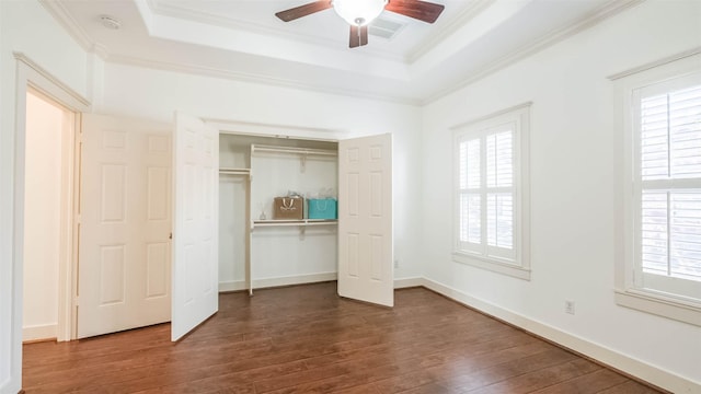 1045 W 16th St, Houston, TX 77008 - unfurnished bedroom with a raised ceiling, dark wood-type flooring, multiple windows, ornamental molding, and a closet