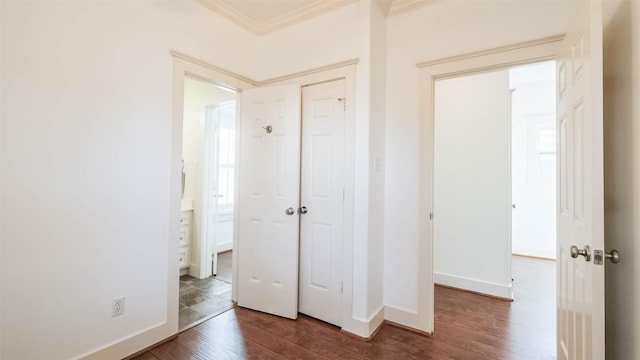 1045 W 16th St, Houston, TX 77008 - unfurnished bedroom with wood finished floors, ornamental molding, a closet, multiple windows, and connected bathroom
