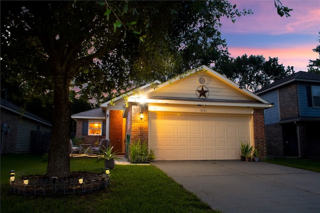 9731 Gulfstream Dr, Conroe, TX 77303 - view of front of property featuring brick siding, concrete driveway, an attached garage, and a yard