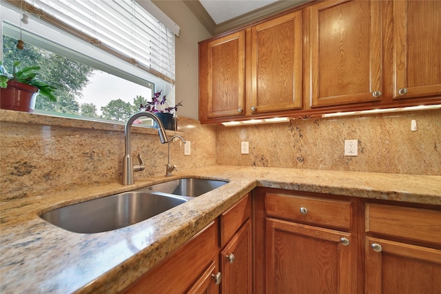 9731 Gulfstream Dr, Conroe, TX 77303 - kitchen with brown cabinets, decorative backsplash, and light stone counters