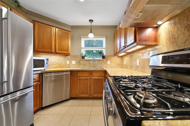 9731 Gulfstream Dr, Conroe, TX 77303 - kitchen with appliances with stainless steel finishes, extractor fan, brown cabinets, decorative backsplash, and ornamental molding