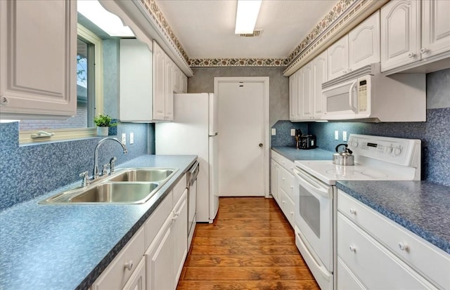 1403 Newport Blvd, League City, TX 77573 - kitchen with white appliances, dark wood-type flooring, white cabinetry, and decorative backsplash
