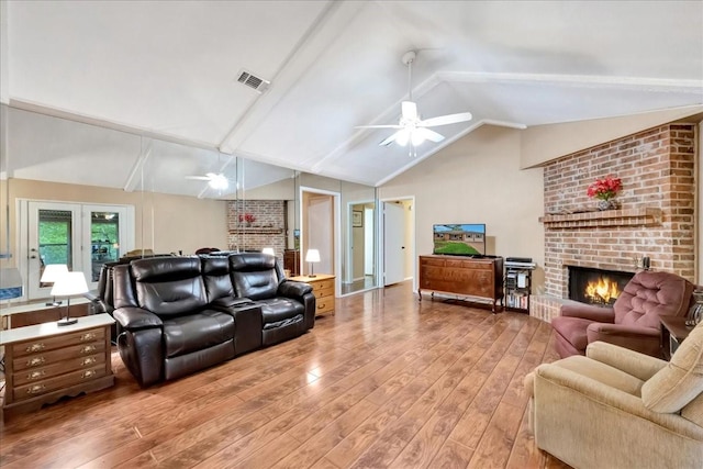1403 Newport Blvd, League City, TX 77573 - living room with a fireplace, ceiling fan, and light wood-type flooring