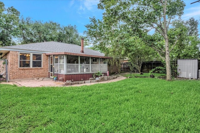1403 Newport Blvd, League City, TX 77573 - back of property featuring a sunroom, a fenced backyard, a patio, brick siding, and roof with shingles