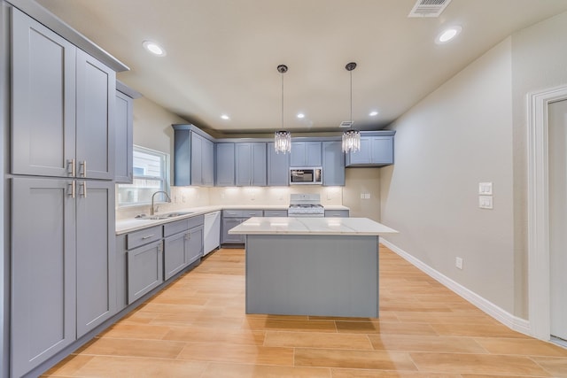 2142 De Soto St, Houston, TX 77091 - kitchen with white appliances, a center island, pendant lighting, tasteful backsplash, and light wood-style flooring