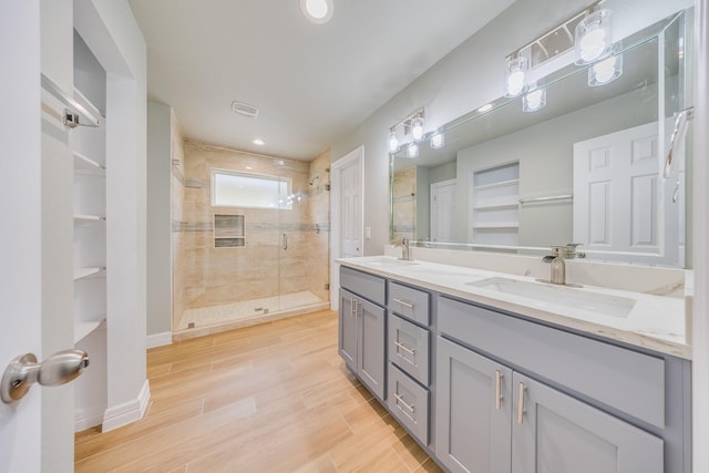 2142 De Soto St, Houston, TX 77091 - full bathroom with a stall shower, double vanity, wood finished floors, and recessed lighting