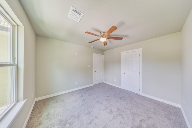 2142 De Soto St, Houston, TX 77091 - carpeted empty room with a ceiling fan and plenty of natural light