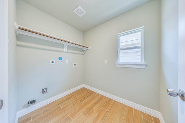 2142 De Soto St, Houston, TX 77091 - laundry room featuring electric dryer hookup, washer hookup, and light wood-style floors