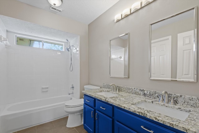 2625 Seashore Dr, Seabrook, TX 77586 - full bath featuring double vanity, shower / washtub combination, tile patterned floors, and a textured ceiling