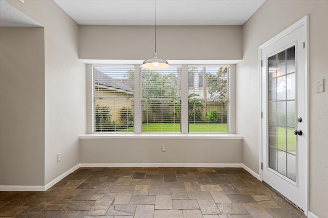2625 Seashore Dr, Seabrook, TX 77586 - unfurnished dining area featuring healthy amount of natural light and stone tile floors