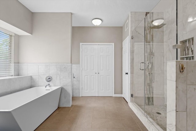 2625 Seashore Dr, Seabrook, TX 77586 - bathroom featuring a freestanding bath, a stall shower, and tile patterned floors