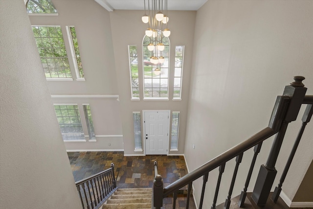 2625 Seashore Dr, Seabrook, TX 77586 - foyer entrance with stone finish floors, stairway, and a high ceiling