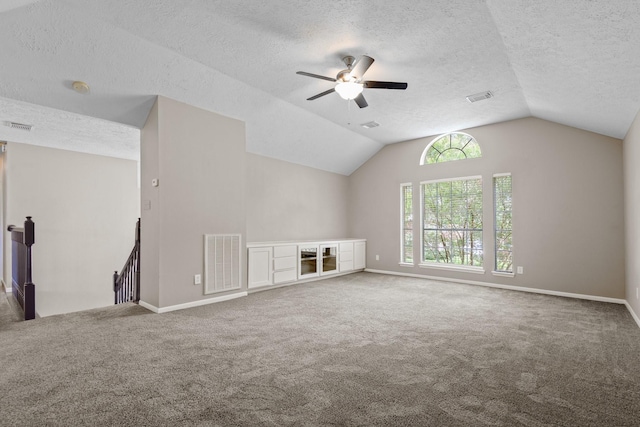 2625 Seashore Dr, Seabrook, TX 77586 - unfurnished living room featuring a textured ceiling, lofted ceiling, carpet, and ceiling fan