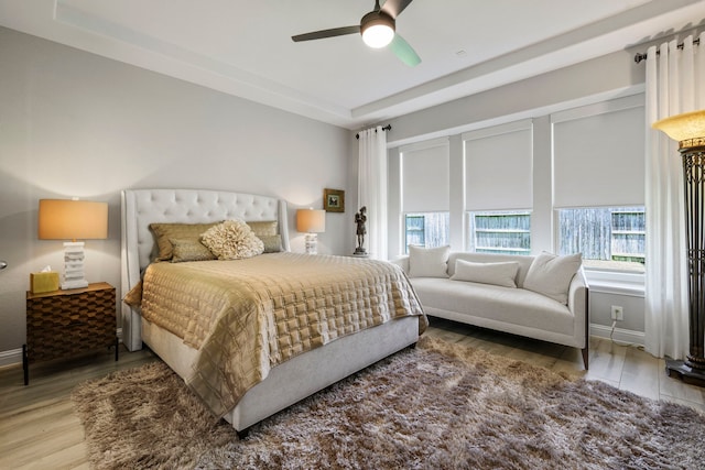 14926 Violet Willow Ct, Cypress, TX 77429 - bedroom featuring wood finished floors, a ceiling fan, and a tray ceiling