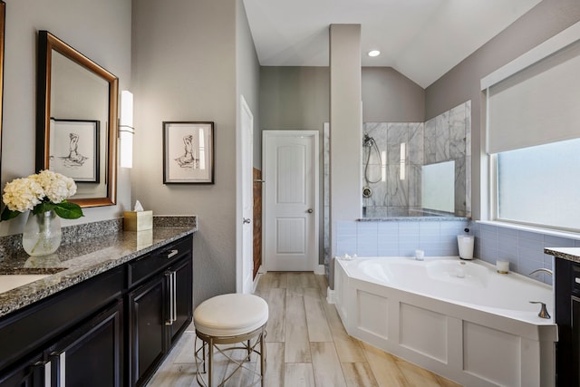 14926 Violet Willow Ct, Cypress, TX 77429 - full bath featuring a tile shower, vanity, a garden tub, vaulted ceiling, and wood finished floors