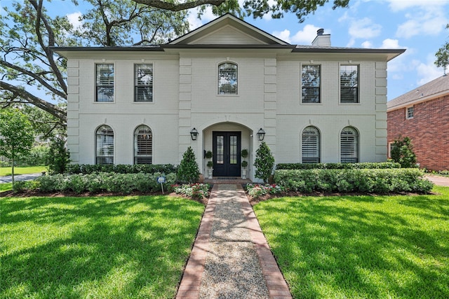 5001 Wedgewood Dr, Bellaire, TX 77401 - view of front of house with french doors, a front lawn, and brick siding