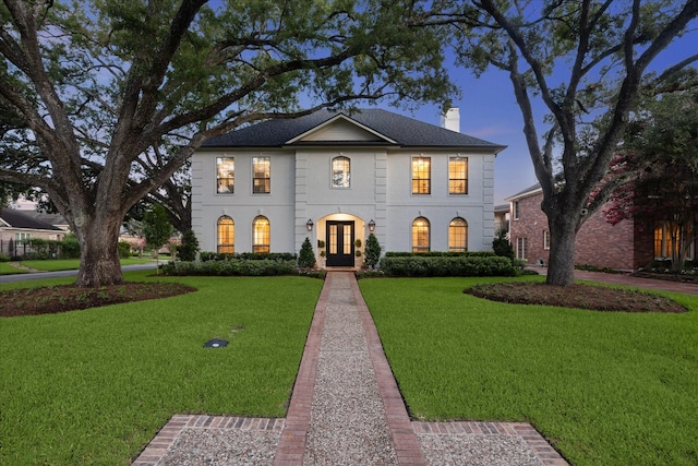 5001 Wedgewood Dr, Bellaire, TX 77401 - view of front of home with french doors, a chimney, and a front yard