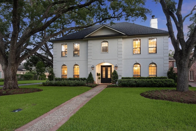 5001 Wedgewood Dr, Bellaire, TX 77401 - view of front of home with a chimney, french doors, a front lawn, and brick siding