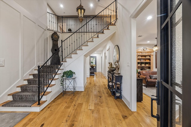 5001 Wedgewood Dr, Bellaire, TX 77401 - entryway with stairs, wood-type flooring, a chandelier, and a high ceiling