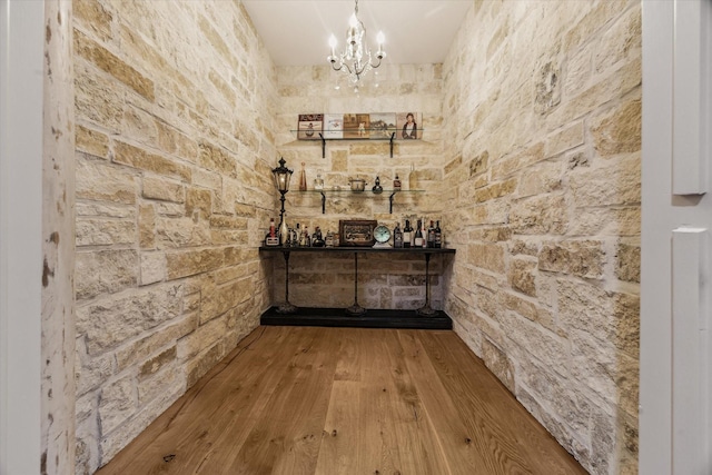 5001 Wedgewood Dr, Bellaire, TX 77401 - wine cellar featuring hardwood / wood-style flooring, a chandelier, and a bar