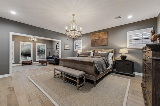 5001 Wedgewood Dr, Bellaire, TX 77401 - bedroom featuring a chandelier, light wood-style flooring, and recessed lighting
