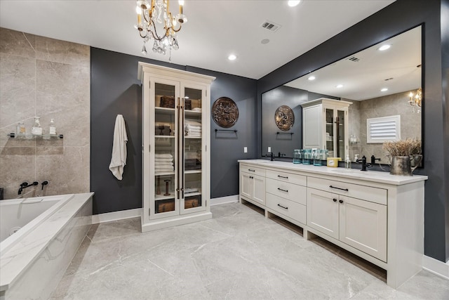 5001 Wedgewood Dr, Bellaire, TX 77401 - full bathroom featuring double vanity, a tub with jets, a chandelier, marble finish floors, and recessed lighting