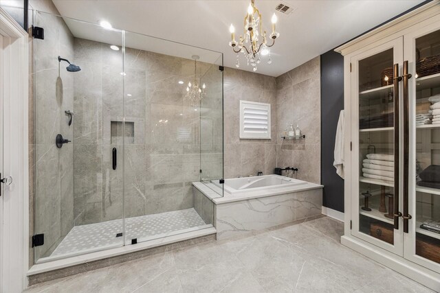 5001 Wedgewood Dr, Bellaire, TX 77401 - full bathroom with a bath, marble tiled floors, a stall shower, and a chandelier