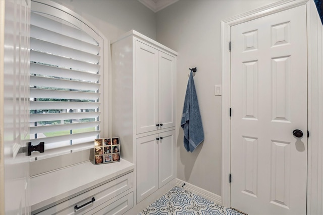 5001 Wedgewood Dr, Bellaire, TX 77401 - mudroom featuring light tile patterned floors and ornamental molding