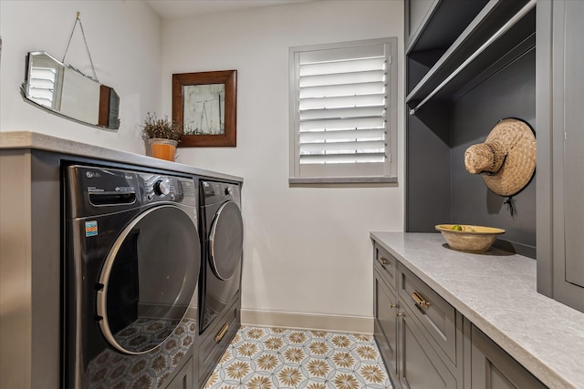 5001 Wedgewood Dr, Bellaire, TX 77401 - washroom with independent washer and dryer, cabinet space, and light tile patterned flooring