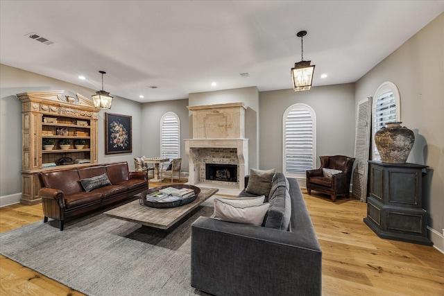 5001 Wedgewood Dr, Bellaire, TX 77401 - living room with light wood-style flooring, a fireplace, recessed lighting, and a chandelier