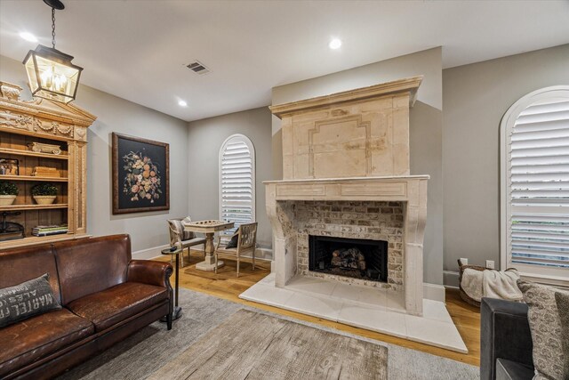 5001 Wedgewood Dr, Bellaire, TX 77401 - living room featuring wood finished floors, a fireplace with raised hearth, and recessed lighting
