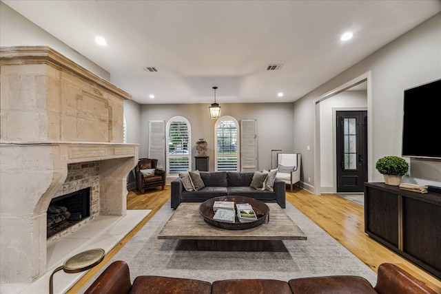 5001 Wedgewood Dr, Bellaire, TX 77401 - living area featuring a premium fireplace, light wood finished floors, and recessed lighting