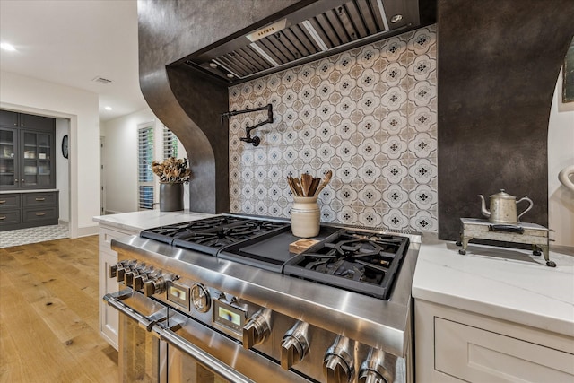5001 Wedgewood Dr, Bellaire, TX 77401 - kitchen featuring double oven range, custom range hood, light wood finished floors, light stone counters, and recessed lighting