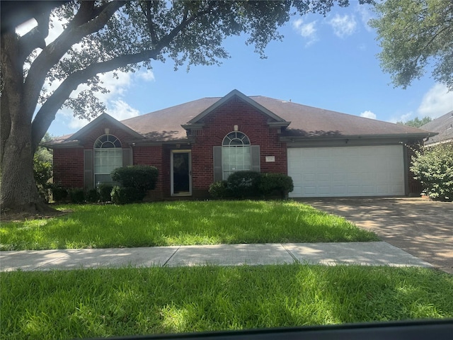 3718 Brighton Ln, Pearland, TX 77584 - ranch-style home with brick siding, a garage, concrete driveway, and a front yard
