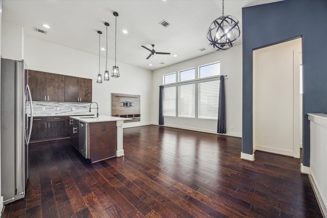 3208 N Macgregor Way Unit C, Houston, TX 77004 - kitchen featuring appliances with stainless steel finishes, ceiling fan, open floor plan, light countertops, and dark brown cabinetry