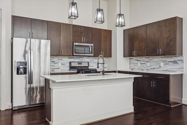 3208 N Macgregor Way Unit C, Houston, TX 77004 - kitchen featuring appliances with stainless steel finishes, dark brown cabinetry, and dark wood-style flooring