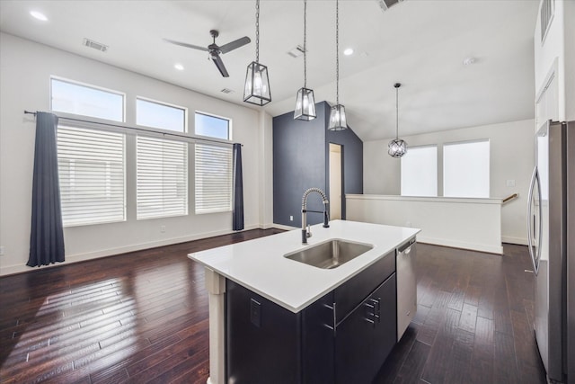 3208 N Macgregor Way Unit C, Houston, TX 77004 - kitchen with appliances with stainless steel finishes, ceiling fan, an island with sink, light countertops, and dark wood finished floors