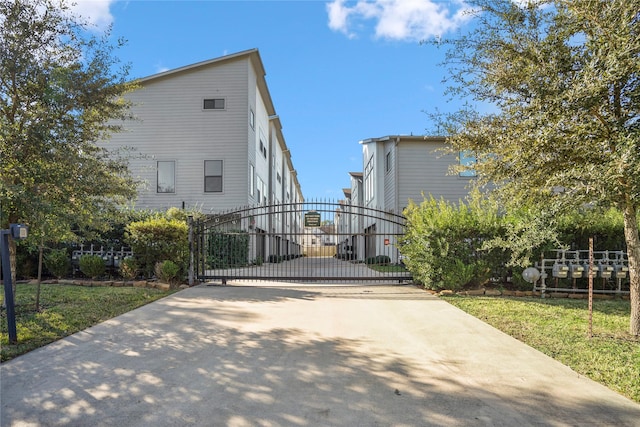 3208 N Macgregor Way Unit C, Houston, TX 77004 - view of concrete driveway featuring a gate and a gated entry