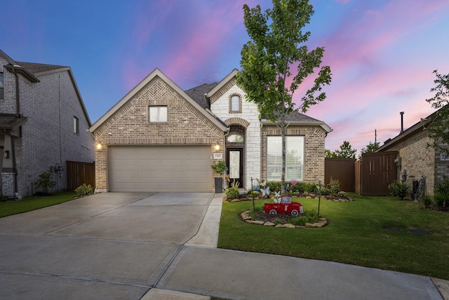 23007 Birchwood Valley Ln, Katy, TX 77493 - french country home featuring brick siding, driveway, and an attached garage