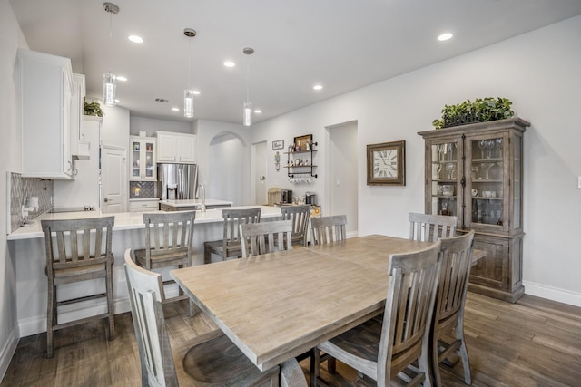 23007 Birchwood Valley Ln, Katy, TX 77493 - dining room with arched walkways, dark wood-style flooring, and recessed lighting