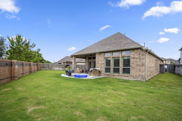 23007 Birchwood Valley Ln, Katy, TX 77493 - rear view of house featuring brick siding, a fenced backyard, a patio, and roof with shingles