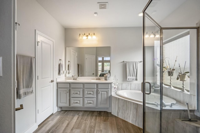 23007 Birchwood Valley Ln, Katy, TX 77493 - full bath featuring double vanity, a garden tub, wood finished floors, and a shower with door