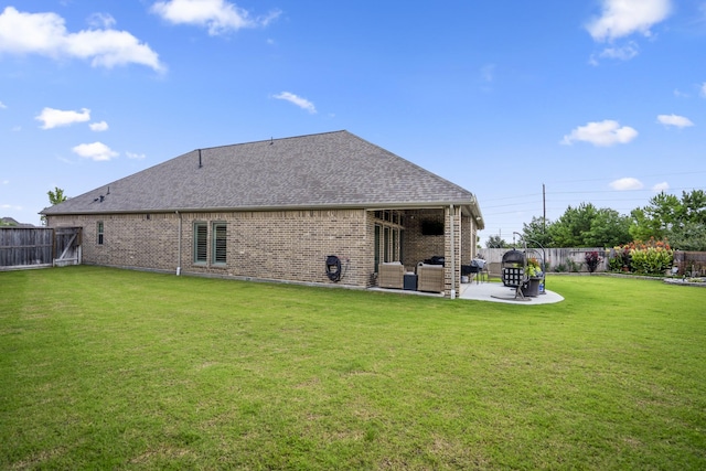23007 Birchwood Valley Ln, Katy, TX 77493 - rear view of house featuring brick siding, a patio, roof with shingles, a fenced backyard, and an outdoor hangout area