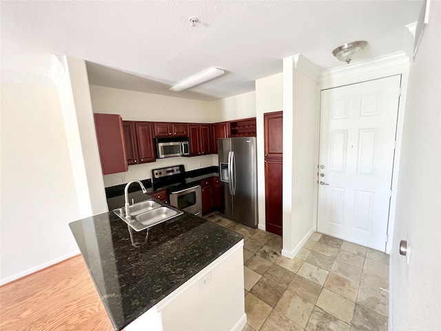 7575 Kirby Dr Unit 1203, Houston, TX 77030 - kitchen featuring appliances with stainless steel finishes, a peninsula, and reddish brown cabinets