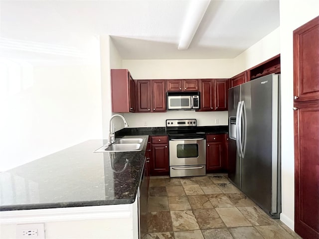 7575 Kirby Dr Unit 1203, Houston, TX 77030 - kitchen with appliances with stainless steel finishes, dark brown cabinets, light stone finish floors, dark stone counters, and a peninsula