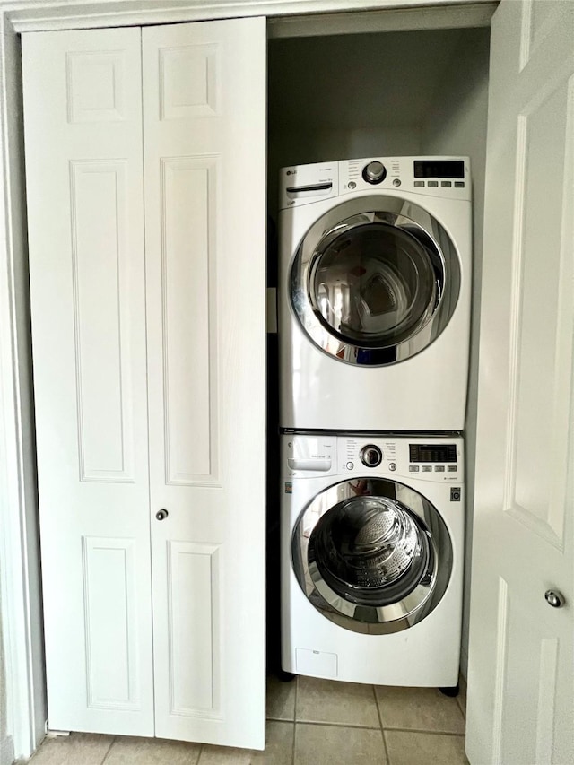 7575 Kirby Dr Unit 1203, Houston, TX 77030 - laundry area featuring estacked washer and dryer and light tile patterned flooring