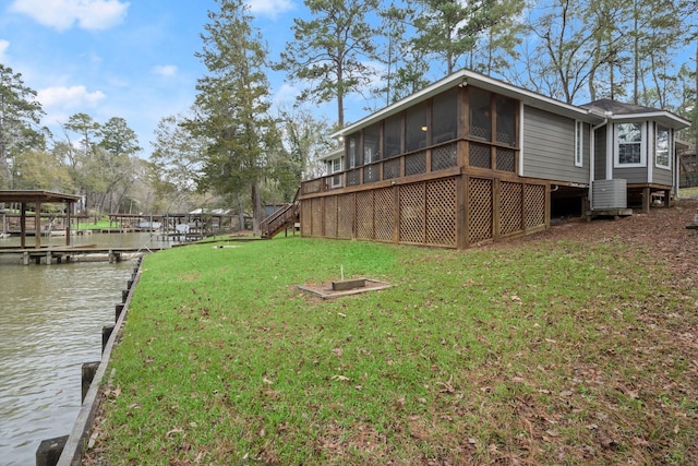 164 Sea Gull Dr, Livingston, TX 77351 - view of grassy yard featuring a sunroom, a water view, a boat dock, and stairway